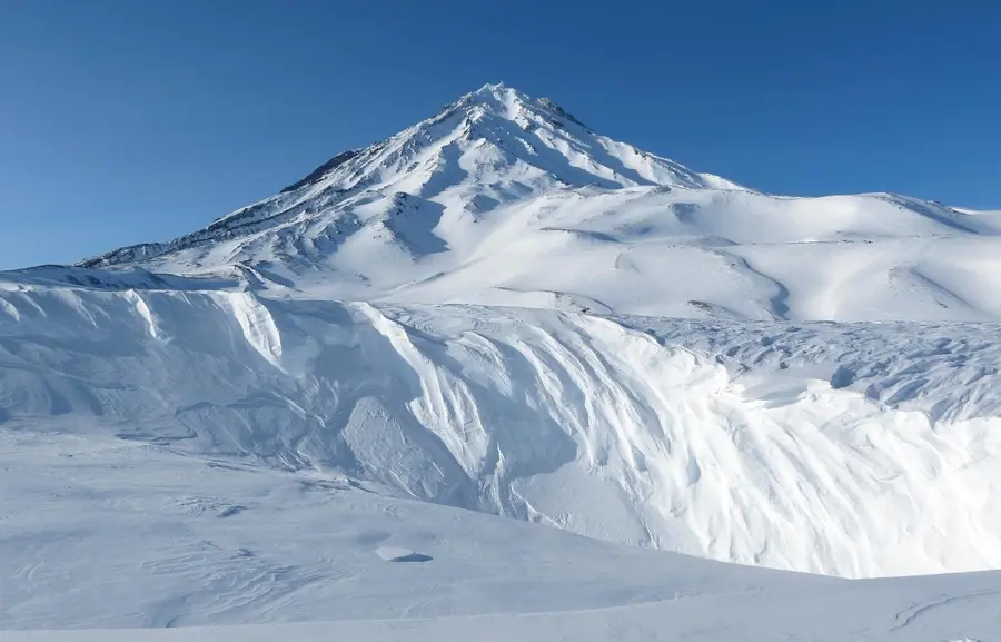 Kamchatka volcano trekking June snow landscape