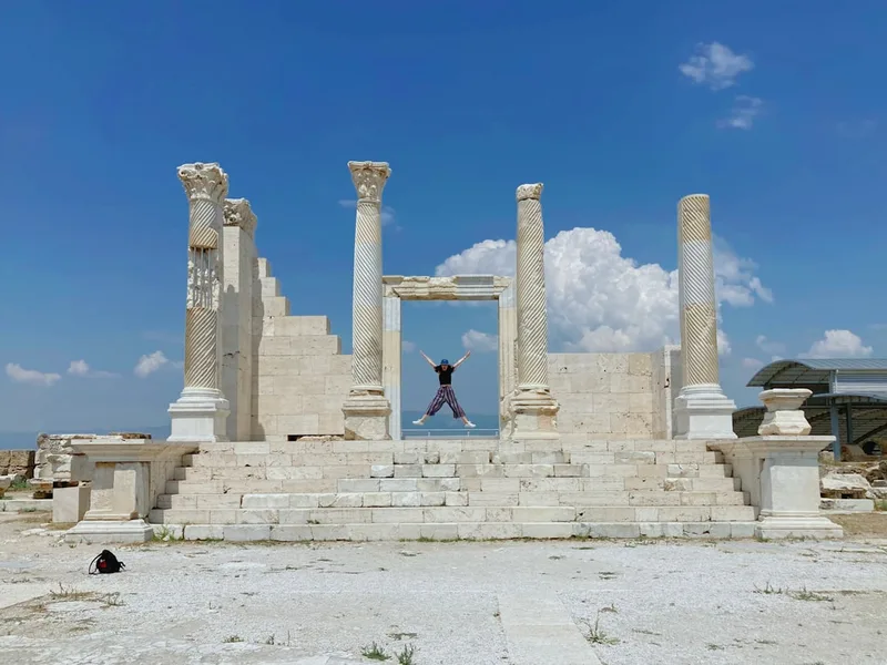Tourist hand touching ancient marble column Side Turkey