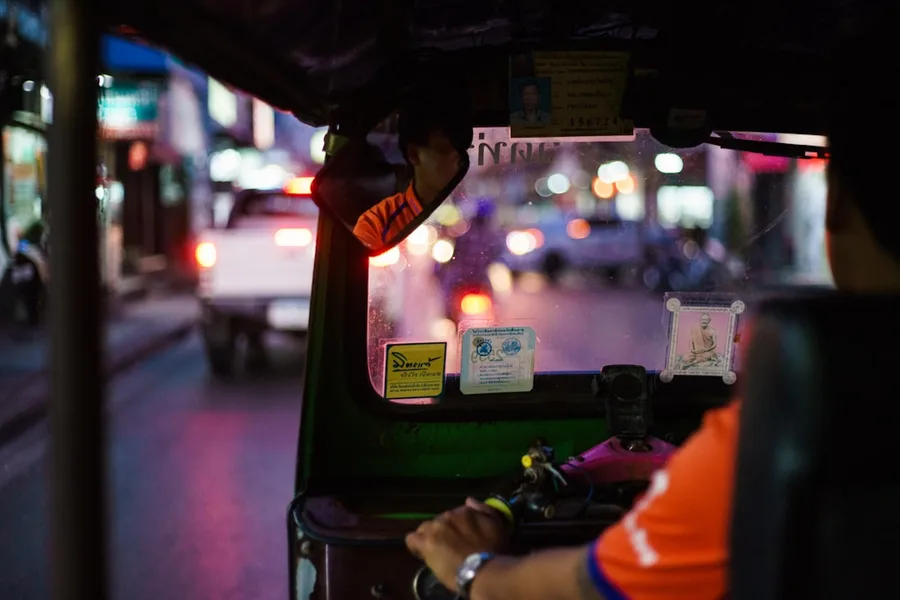 tourist paying with cryptocurrency smartphone taxi Bangkok Thailand Bar Montenegro