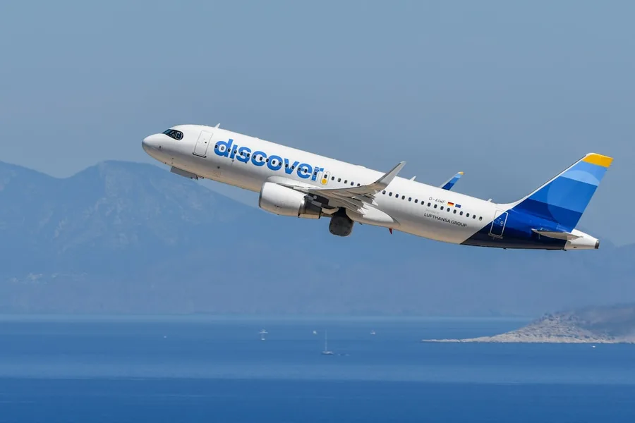 cryptocurrency price chart falling next to flight booking screen Kos Greece