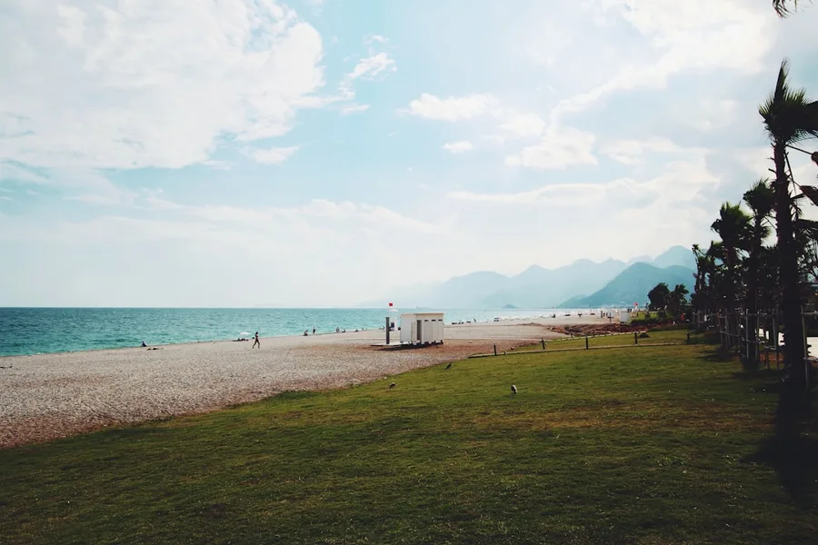 Young couple walking dog on beach Antalya Turkey