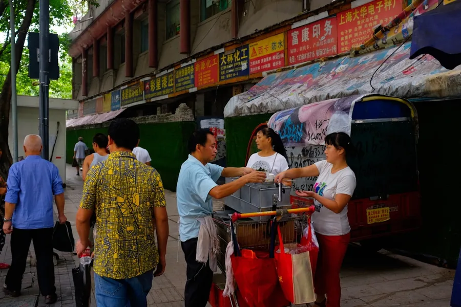 Tourist calculating cost of Chinese transit visa versus free visa-free transit savings China