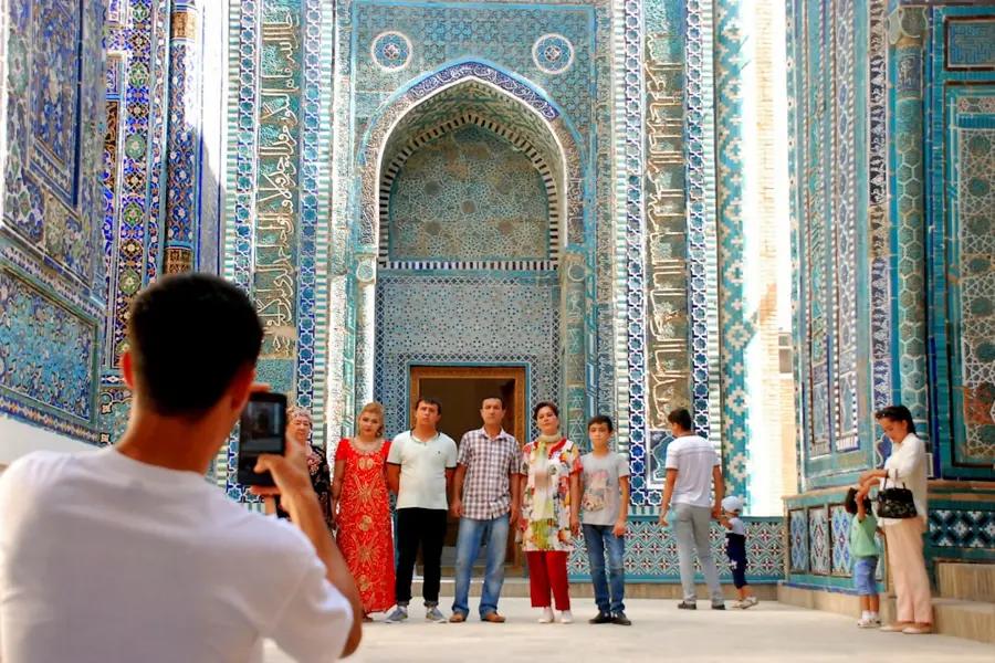 Tourist taking photos with flash forbidden Samarkand