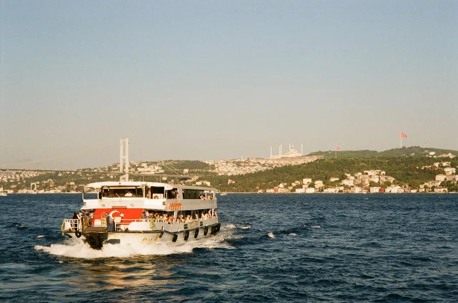 Bosphorus ferry cruise Istanbul skyline tourists Turkey