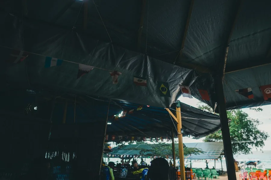 budget traveler checking crypto wallet on phone near food market Phuket Thailand