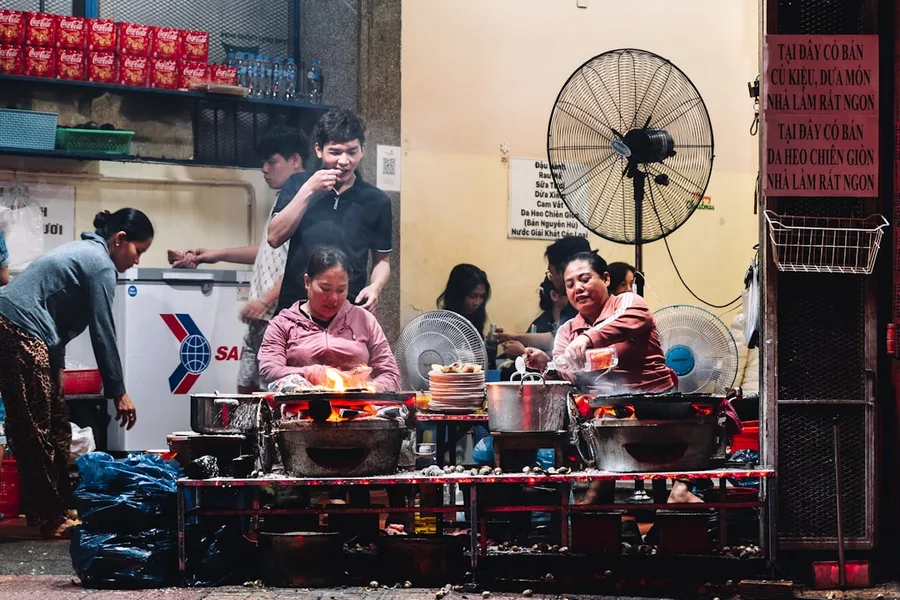 family eating banh mi at local market Nha Trang Vietnam