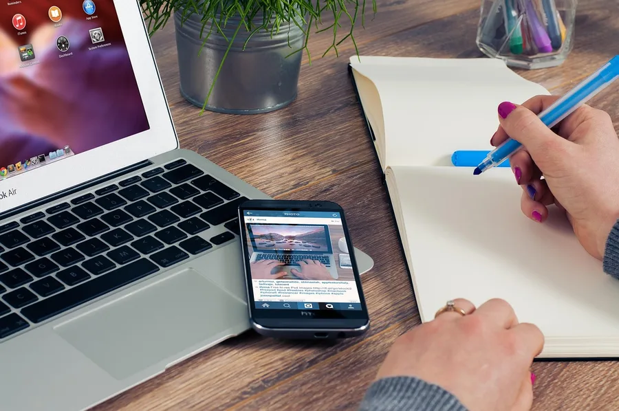 young couple planning trip with laptop miles and crypto card on desk Agra India