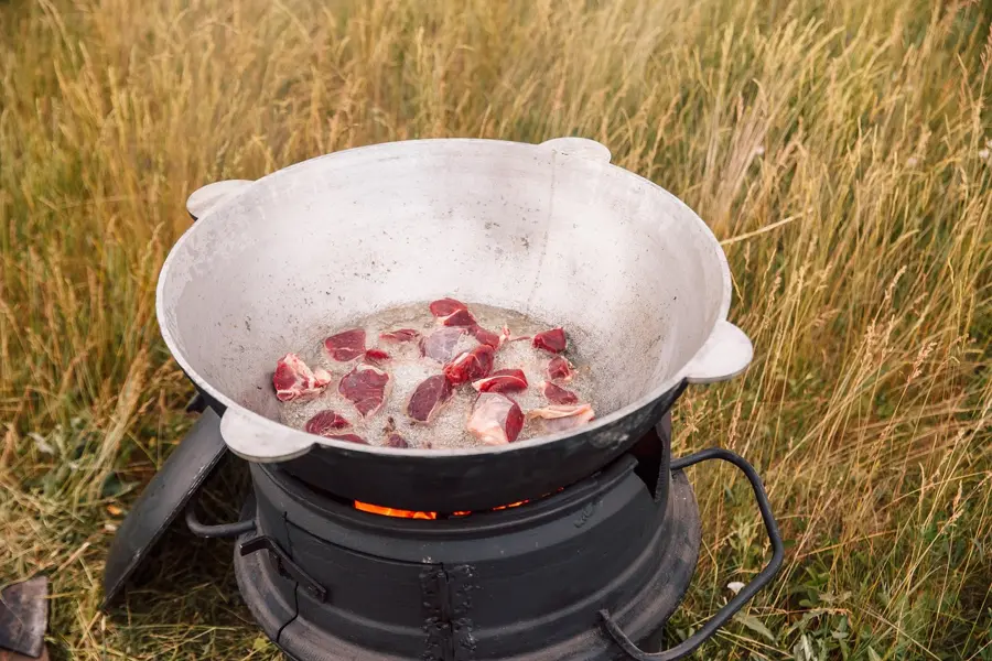 traditional plov cooking in huge kazan