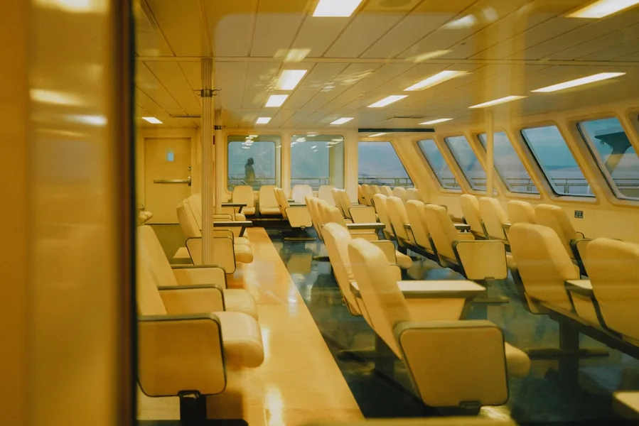 Interior of ferry Igor Farkhutdinov sitting class with reclining seats and large windows looking at the sea