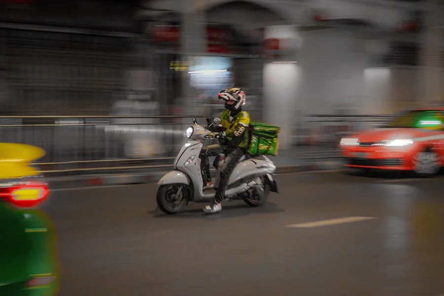 Bangkok local using Grab ride hailing app smartphone