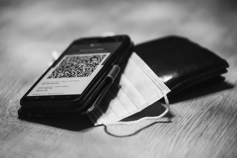 digital nomad paying with cryptocurrency QR code at a beachside cafe Phuket Thailand