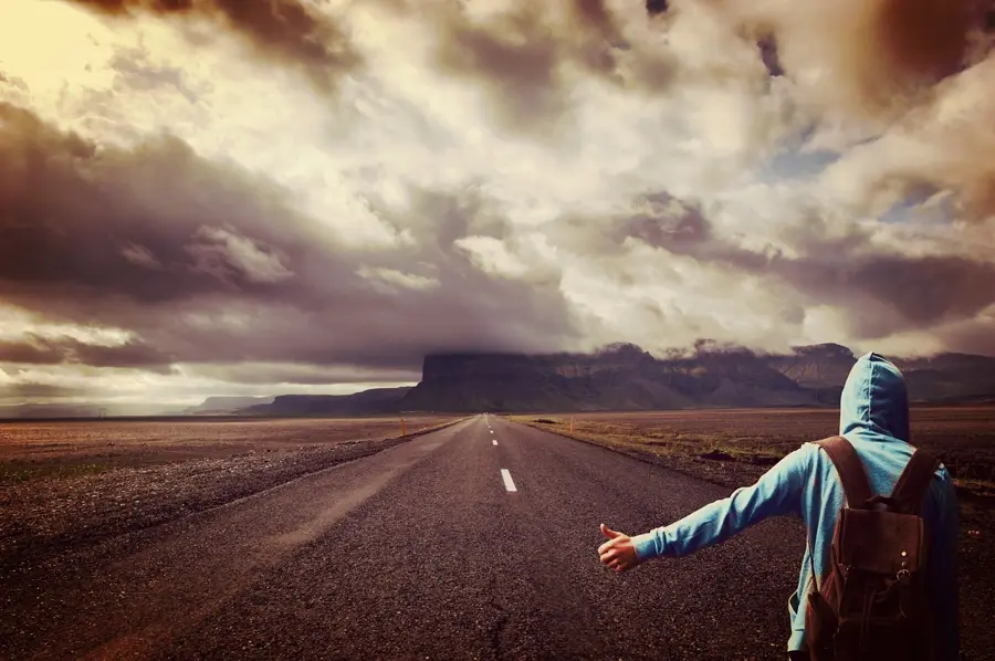 Hitchhiker with backpack on Pamir mountains road