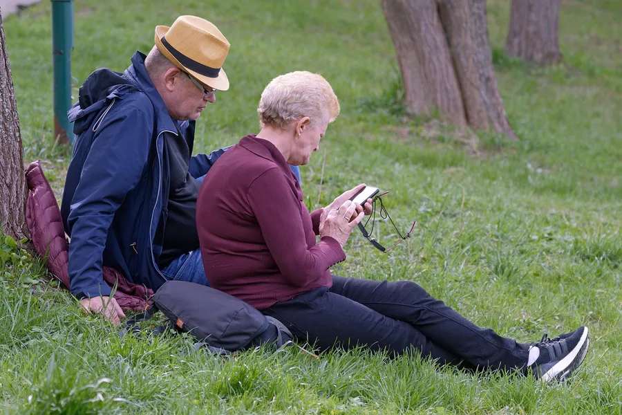 Elderly couple using smartphone map in Antalya old town Turkey