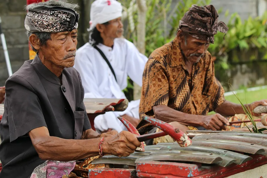 Balinese procession ceremony with tourists watching respectfully Indonesia Osh Kyrgyzstan