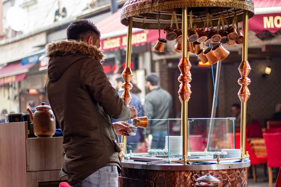 female tourist buying fresh juice street vendor Istanbul Turkey