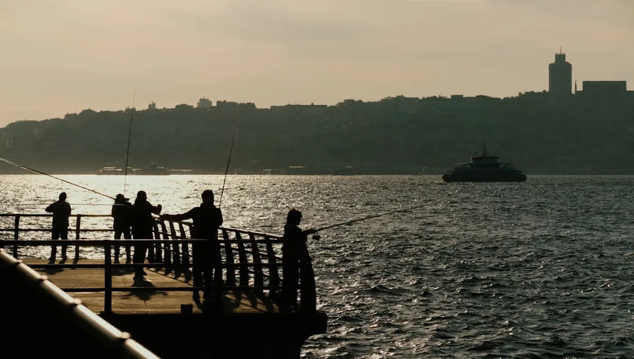 Family enjoying sunset view of Bosphorus from Galata Bridge Istanbul Turkey